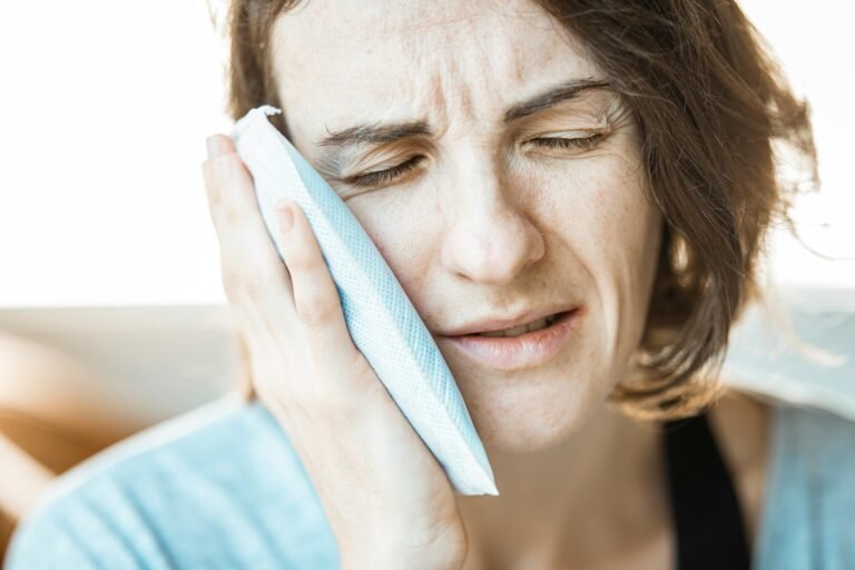 A woman experiencing root canal complications after root canal failure